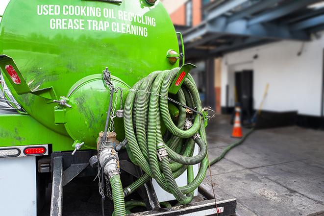 maintenance crew pumping grease trap at a fast food restaurant in Charlottesville IN